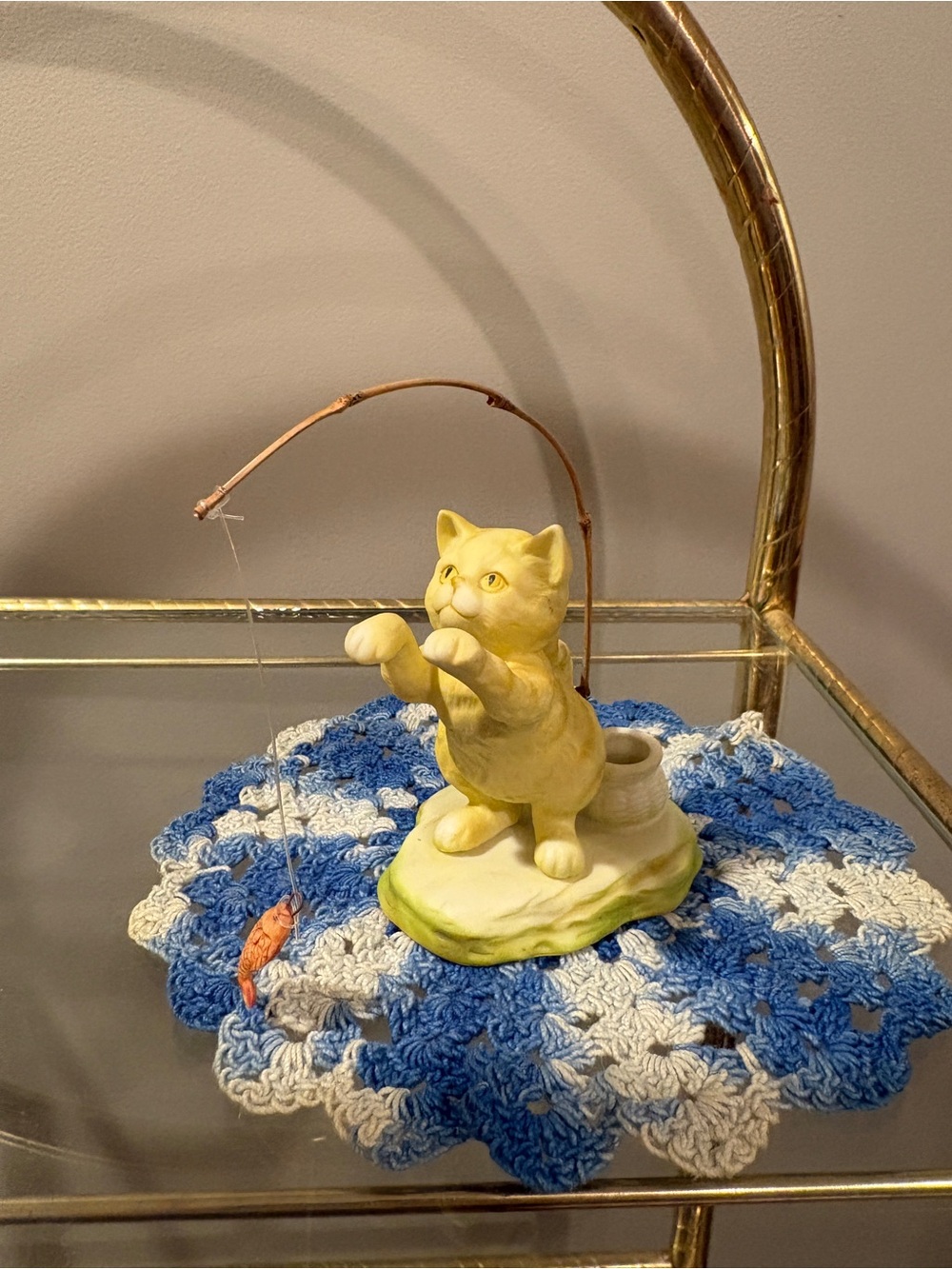 Porcelain fishing cat figurine